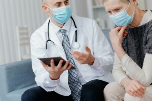 doctor-with-digital-tablet-explaining-something-his-patient (1)