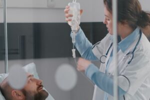 medical-team-monitoring-patient-vital-checking-heart-rate-helping-with-fluids (1)
