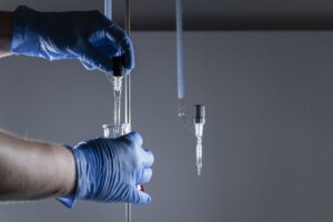 scientist-medical-gloves-holding-test-tubes-analyzing-chemical-samples (1)